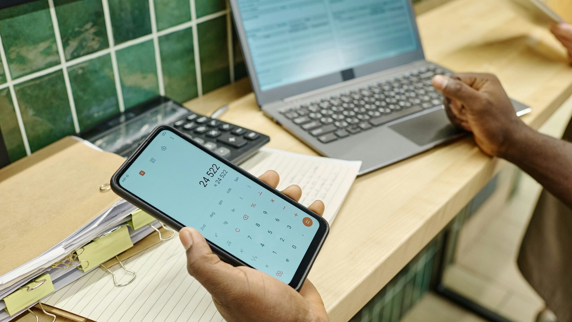 Supermarket worker using calculate at work